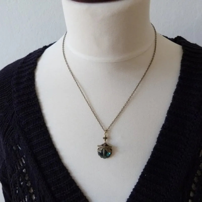 Vintage bronze hand carved dragonfly pendant on a silver chain, yellow colour