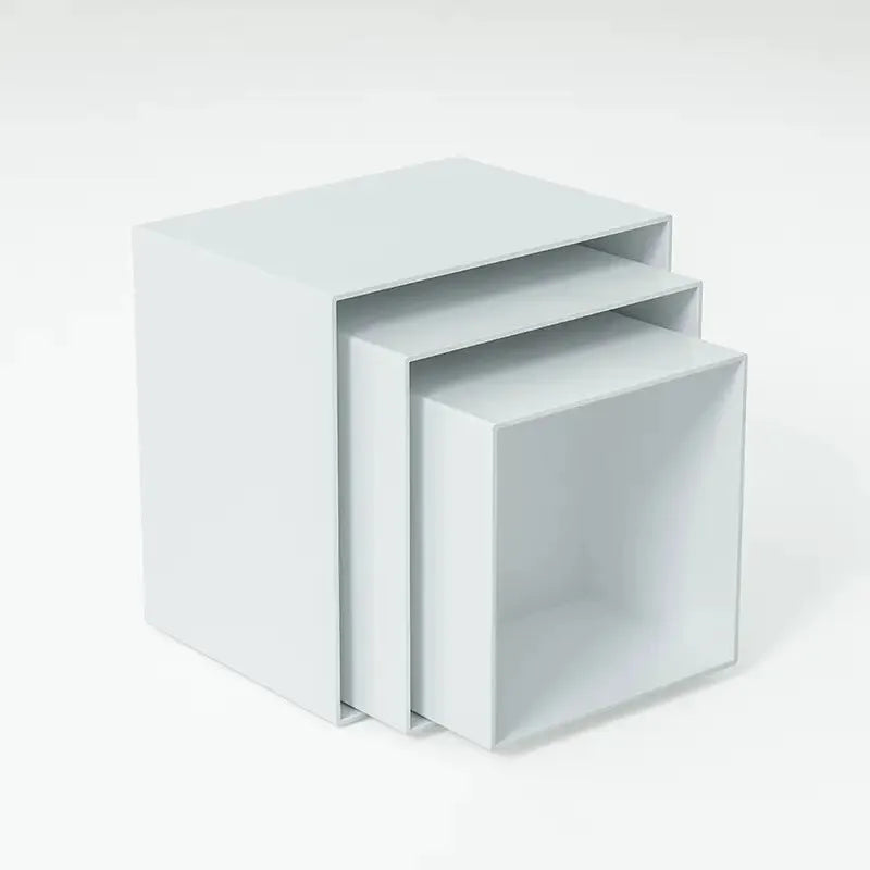 Set of six white geometric plastic cubes arranged as a tiered dessert display stand.