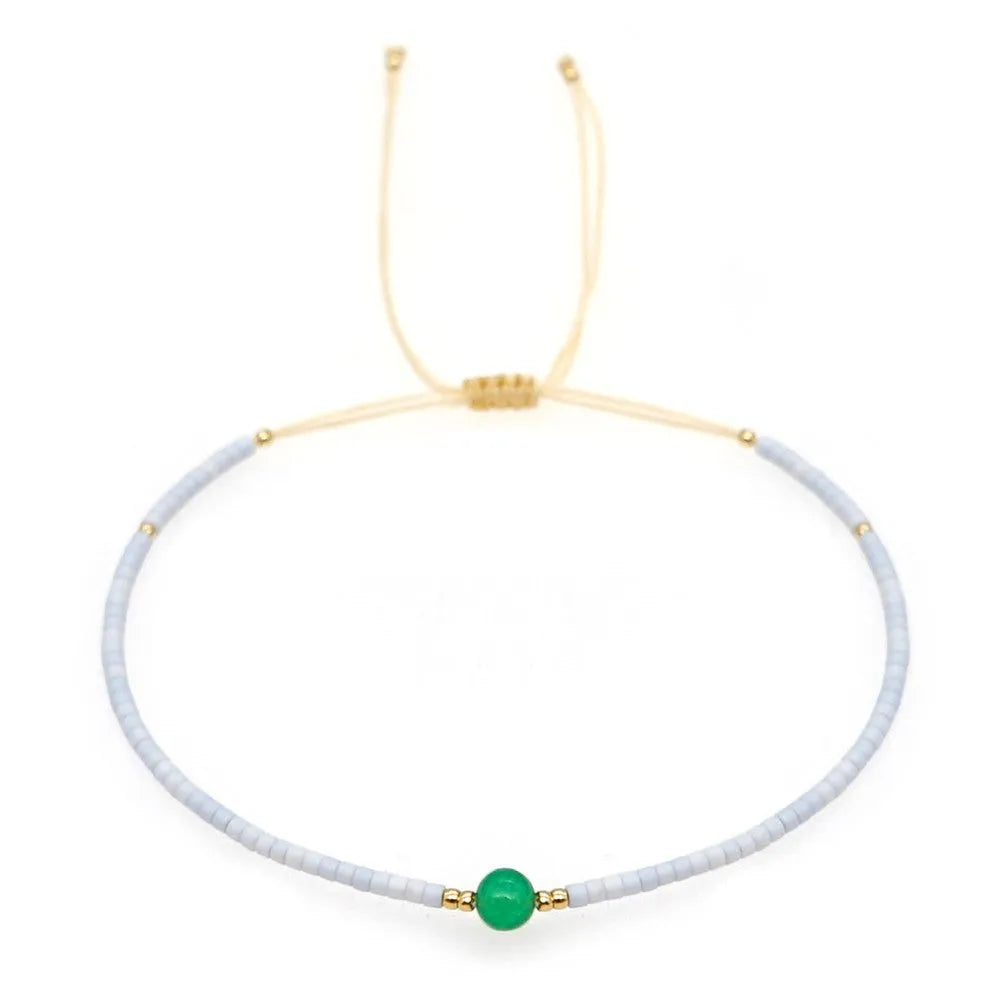 Women's handmade colourful beaded bracelet with geometric glass beads on adjustable cord
