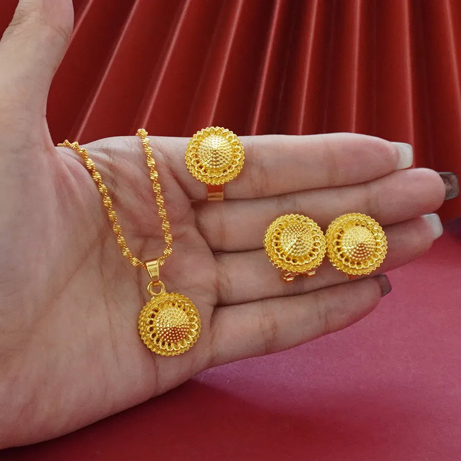 Gold-plated three-piece jewellery suit with landscape Middle East flower designs showing earrings, ring and pendant necklace