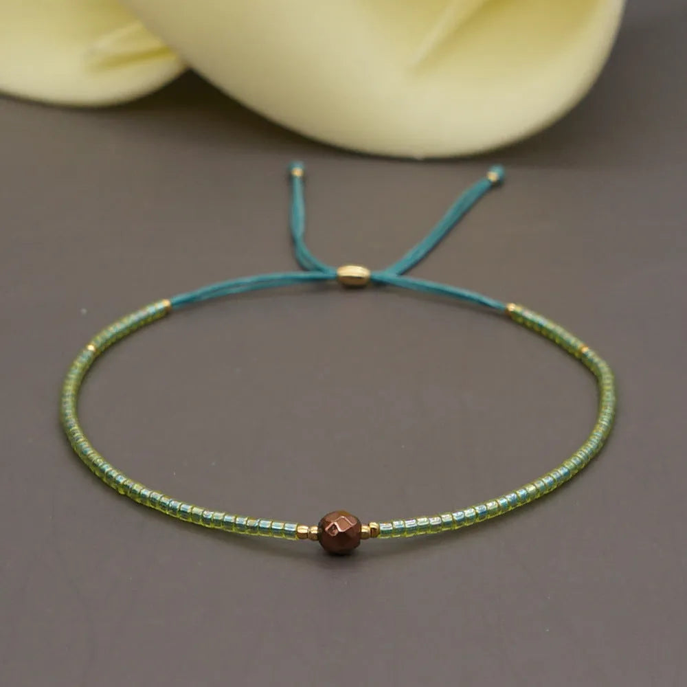 Women's handmade colourful beaded bracelet with geometric glass beads on adjustable cord