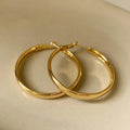 40mm diameter gold and silver metal circle earrings on display
