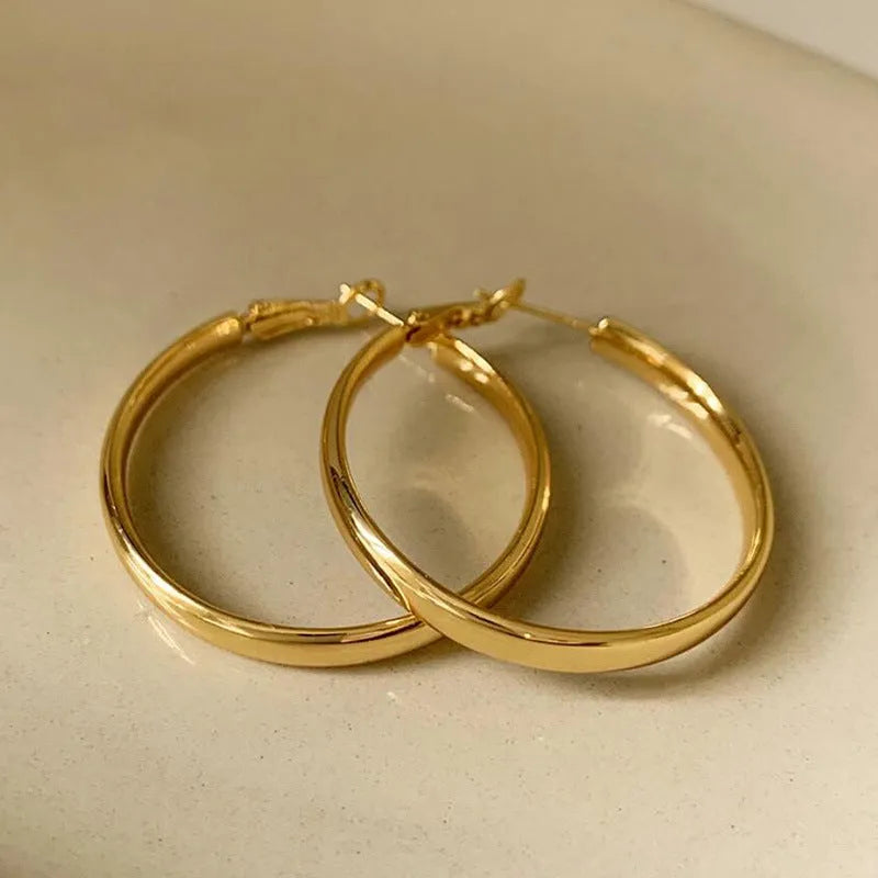 40mm diameter gold and silver metal circle earrings on display