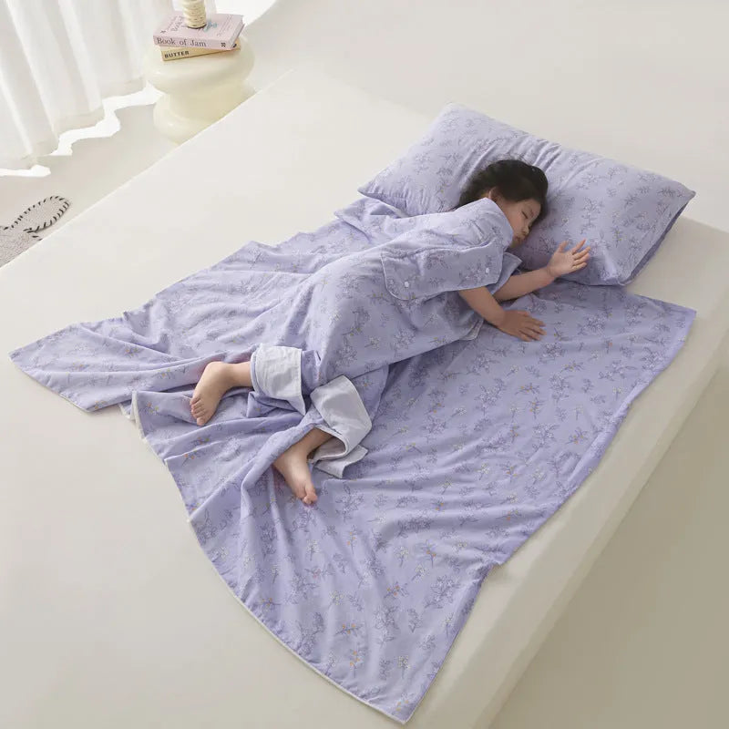 Anti-kick sleeping bag blanket in a summer design on a bed, showing its lightweight texture.
