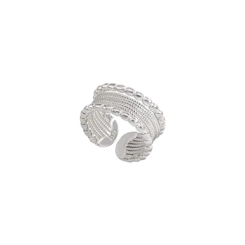Adjustable geometric ring with woven twisted copper design.