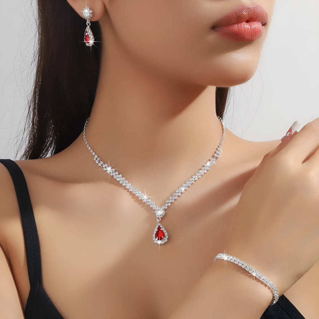Women's blue claw chain necklace and drop rhinestone earrings from a matching jewellery set.