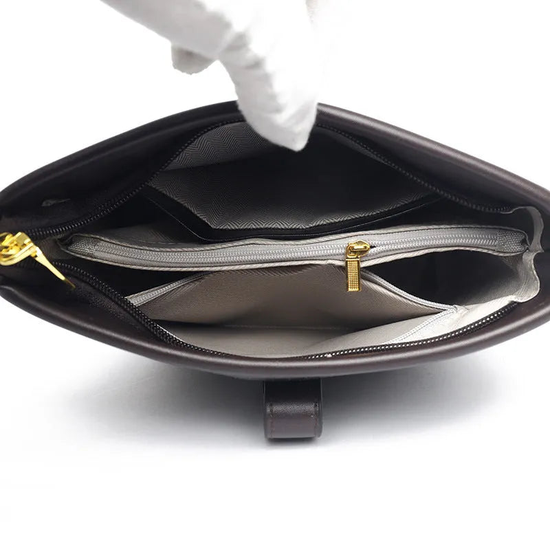 Korean style soft PU bucket messenger bag with adjustable straps in black showing internal zipper compartments