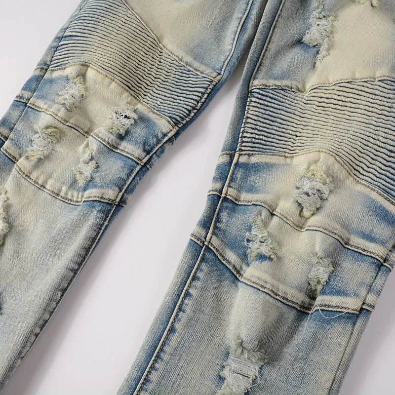 Men's light blue slim fit distressed jeans with hand-frayed details and a straight leg cut.