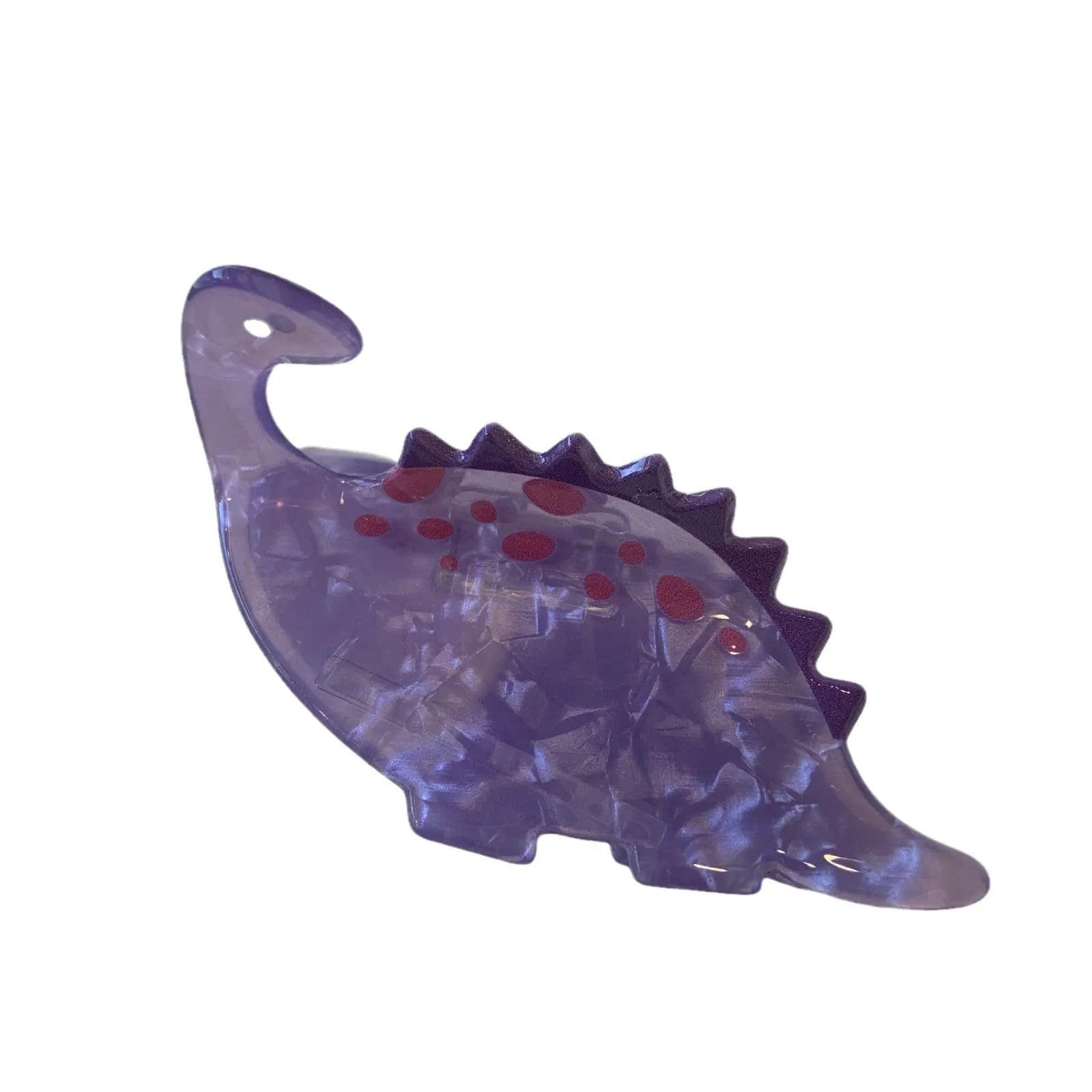 A colourful acrylic jaw clip hair grip featuring a detailed little dinosaur design.