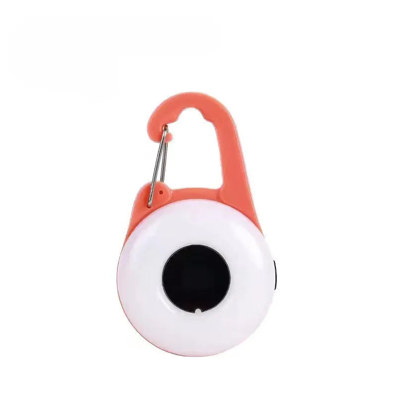 Blue USB rechargeable LED dog walking light with silicone strap attached to a dog collar.