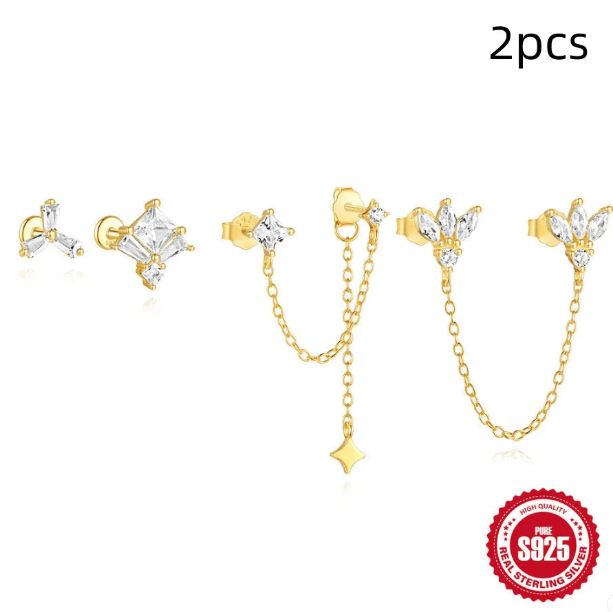 S925 sterling silver geometric stud earrings with inlaid zircon in golden clover, crown, and chain designs.