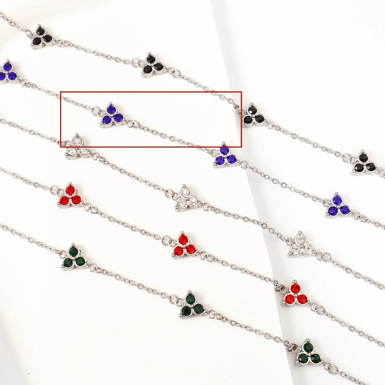 Stainless steel women's bracelet with three triangular diamond motifs set with colourful zircon stones.