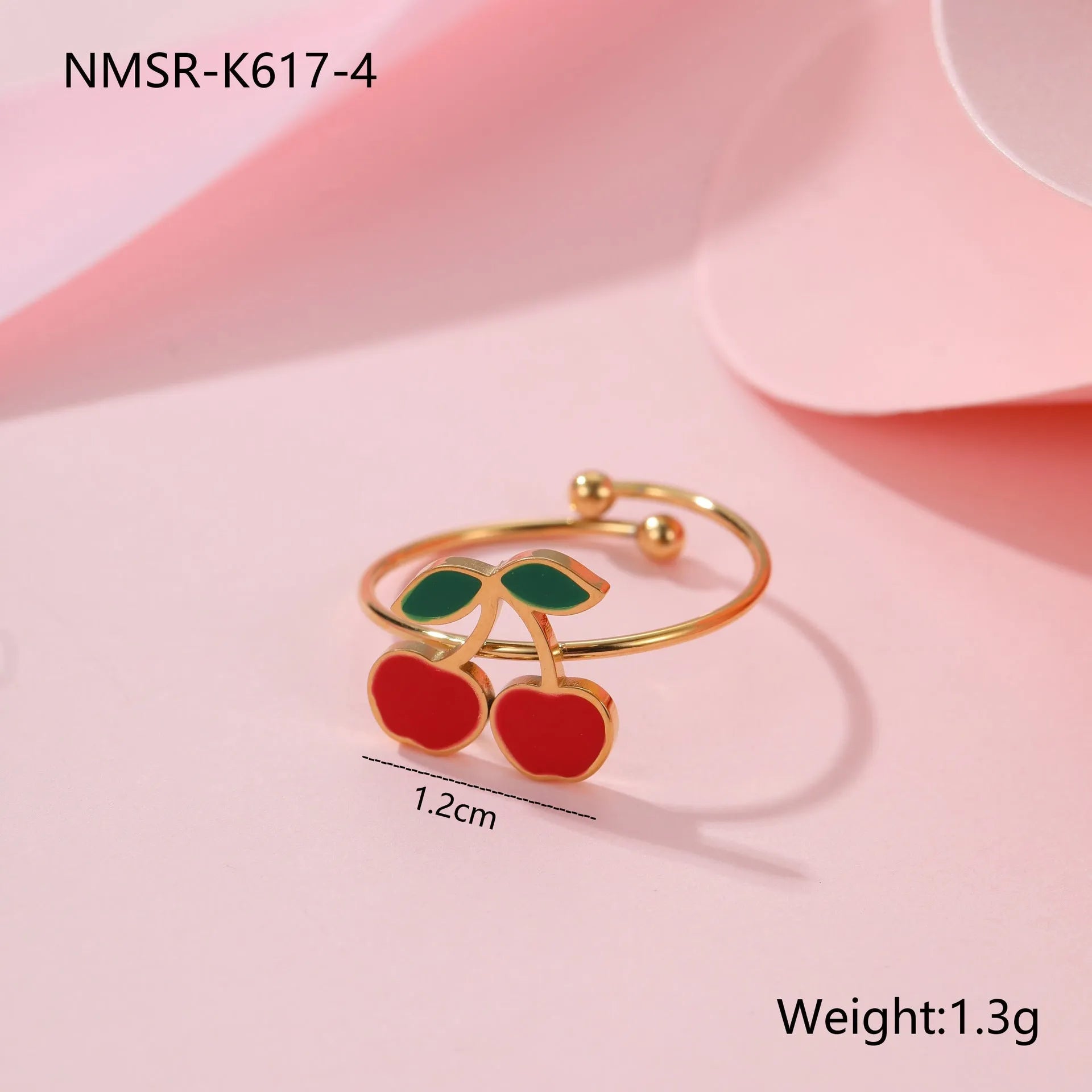 Cherry-themed jewellery set showing stainless steel necklace, bracelet, earrings, and ring with 18K gold plating.