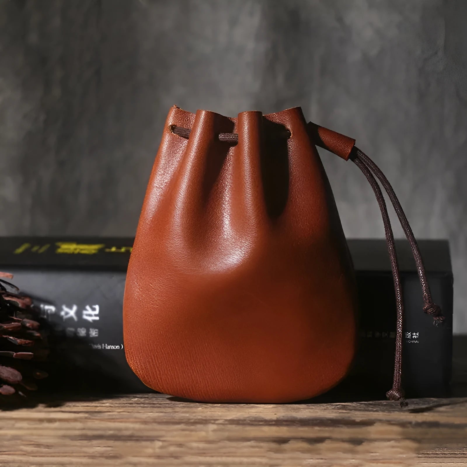 Vintage brown genuine cowhide drawstring bundle wallet laid flat, showing its retro style and stitching details.