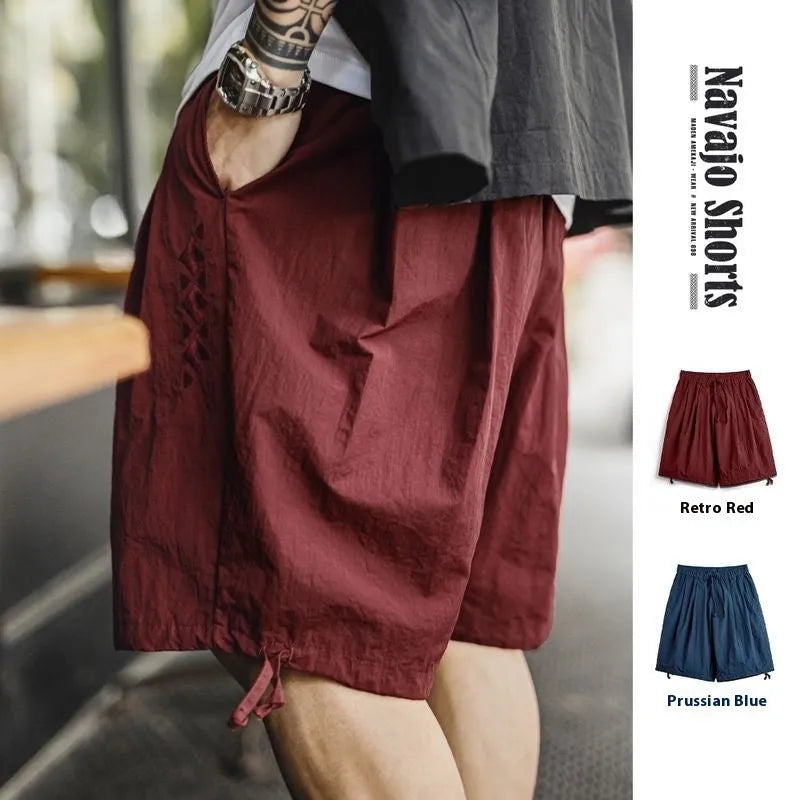 Men's Prussian blue embroidered nylon shorts with loose fit and fifth-pant length