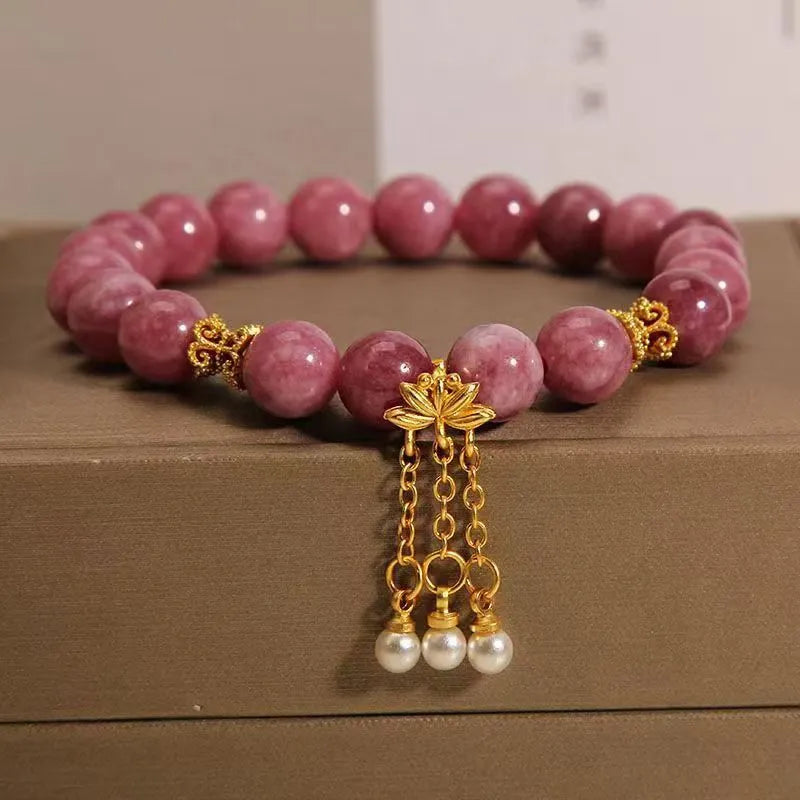 Natural stone bracelet with lotus tassel pendant and pearl details in pink lotus colour