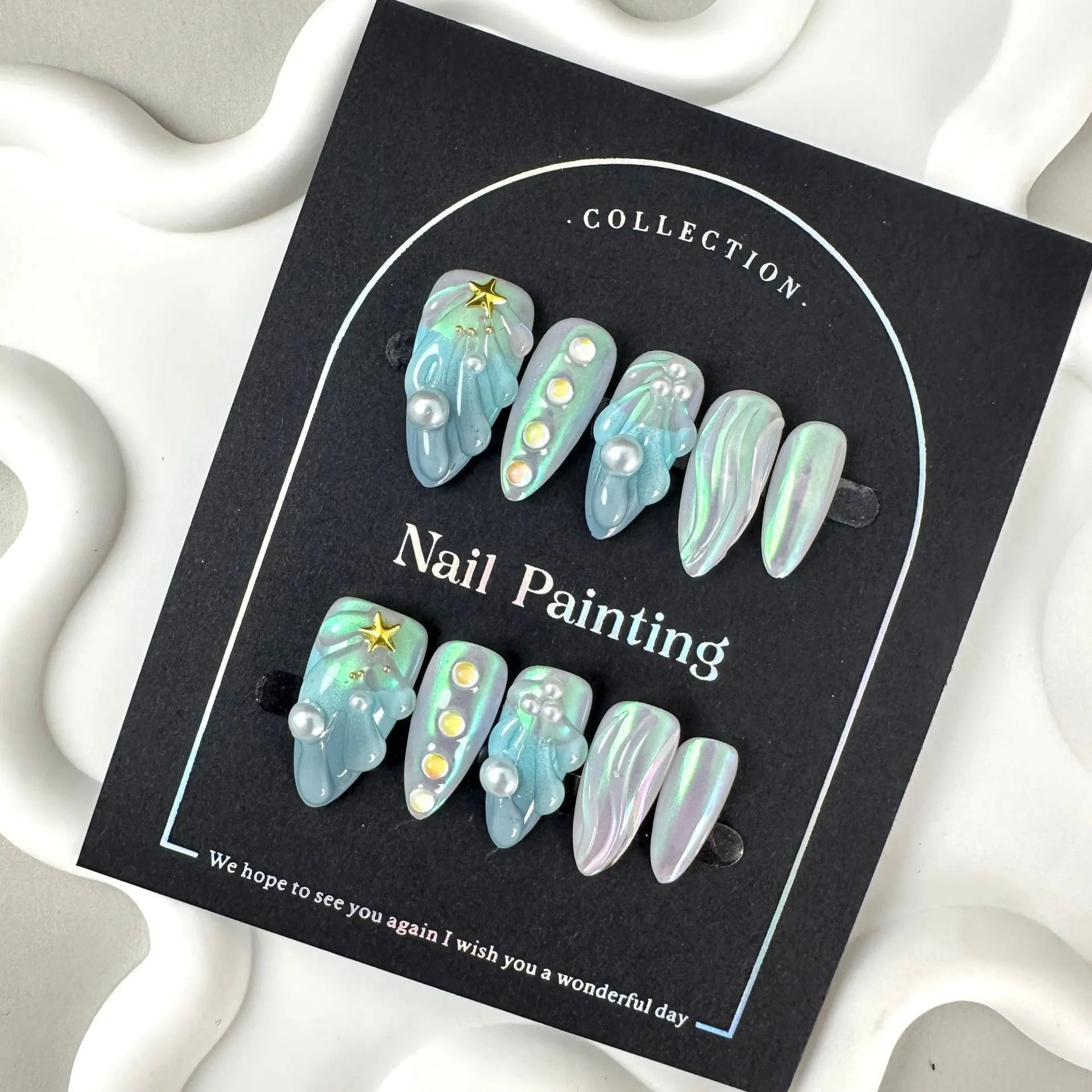 Blue plastic artificial nail tips laid out showing sizes XS S M L