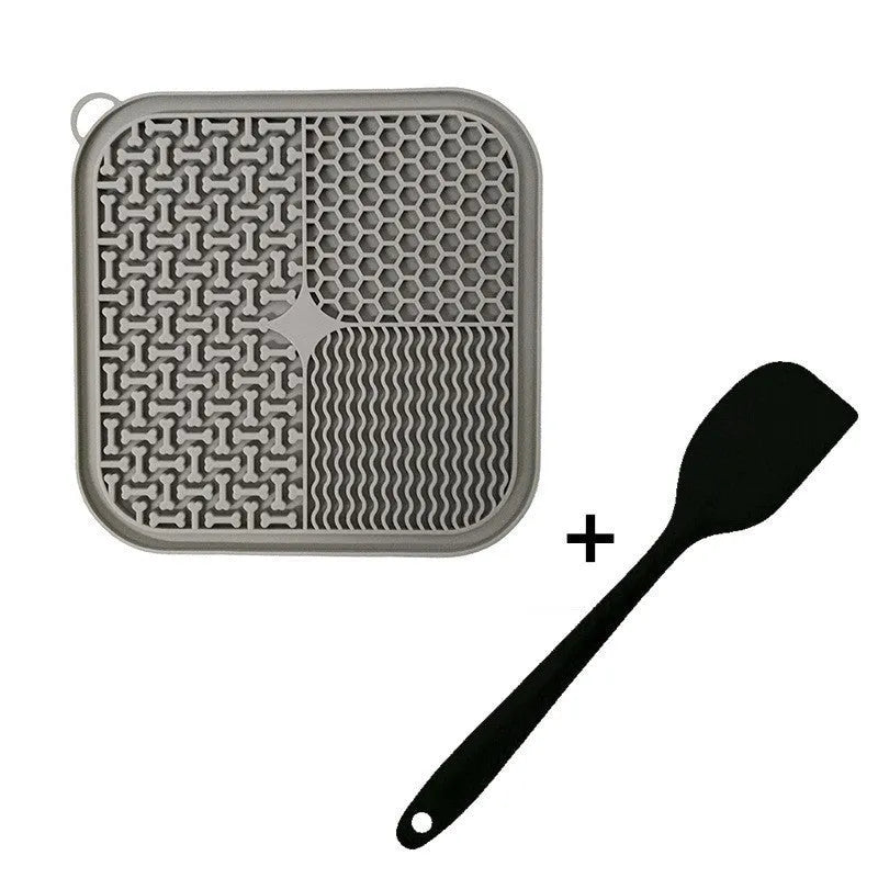 Square orange-red and grey silicone dog lick mat with textured surface and suction cups on the back.