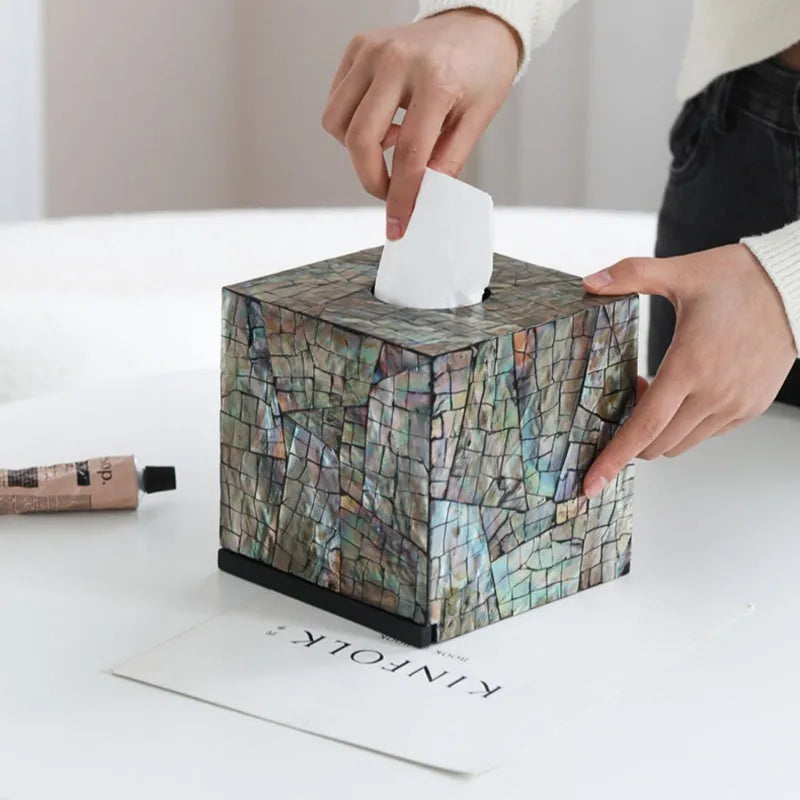Black rectangular natural shell tissue box storage container with removable insert on a table.