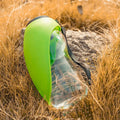 Blue portable pet water bottle with fold-out drinking bowl and carabiner clip for outdoor use