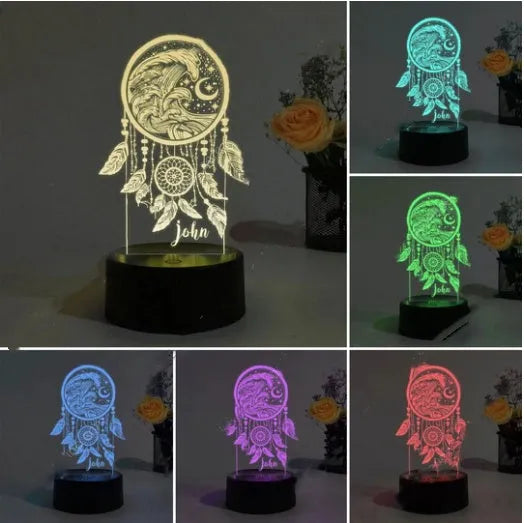 Black-based acrylic dream catcher table lamp with colourful lighting effects on a surface.