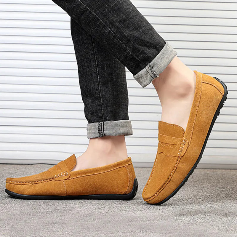 Men's solid colour suede leather slip-on loafers with a flat rubber sole.