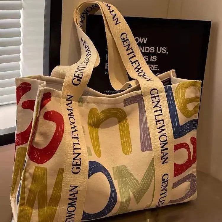 Women's large canvas tote bag with printed design options for travel and shopping.