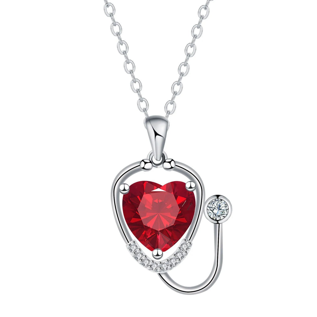 Women's copper necklace with cross, wings, and stethoscope charm in red diamond colour.