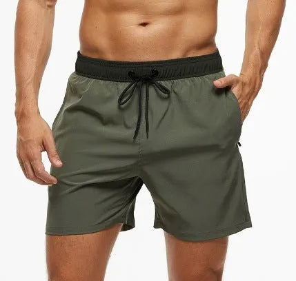 Men's blue drawstring athletic shorts with a zipper pocket and stitching detail on the waistband