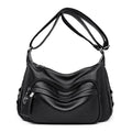 Women's blue soft PU crossbody bag showing interior phone and document compartments with zipper closure