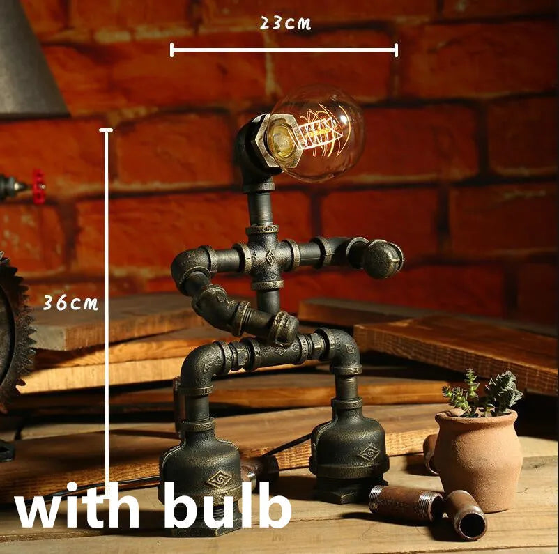 Green bronze vintage robot table lamp with industrial iron pipe design on wooden desk