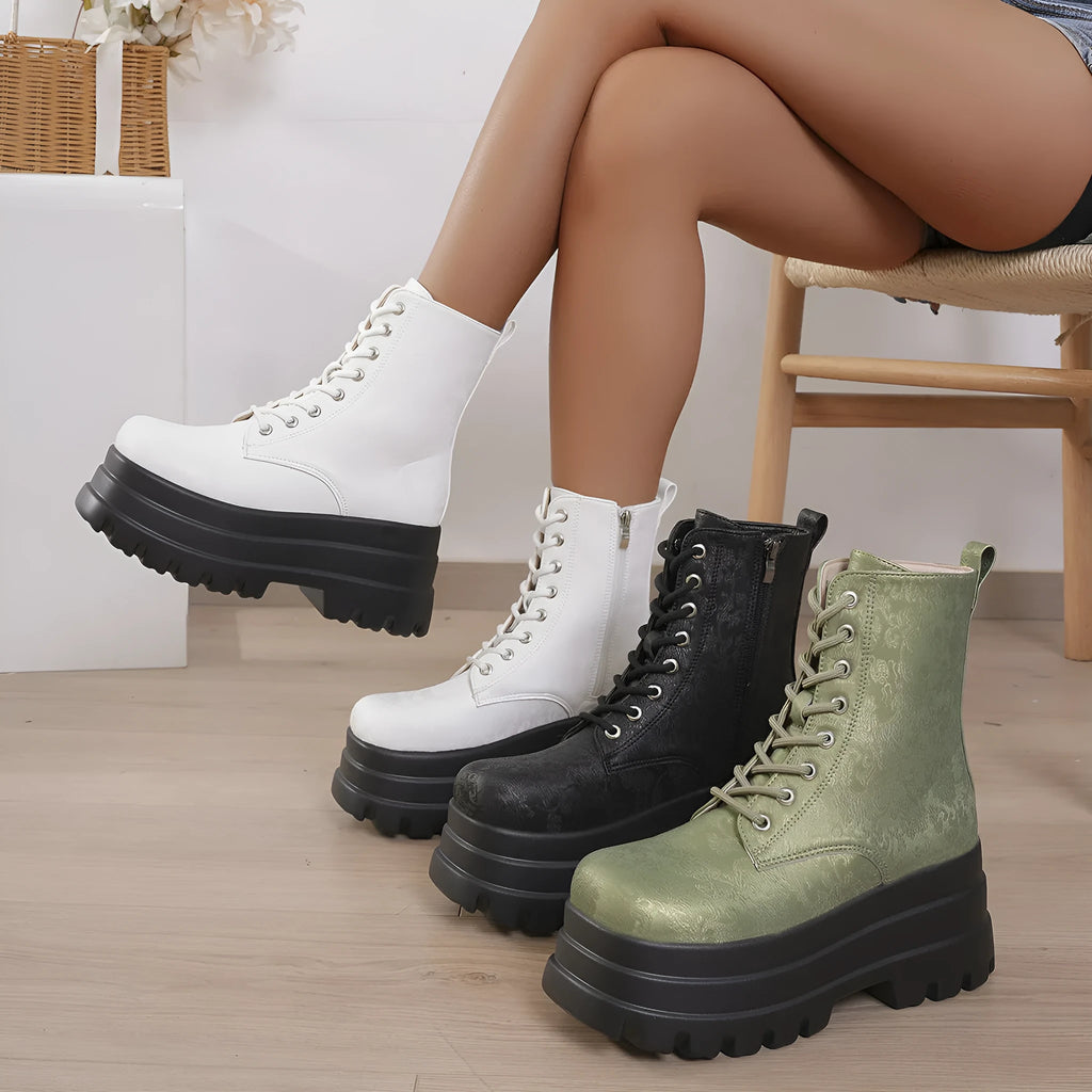 Women's black retro platform Martin boots with patchwork toe and side zip.