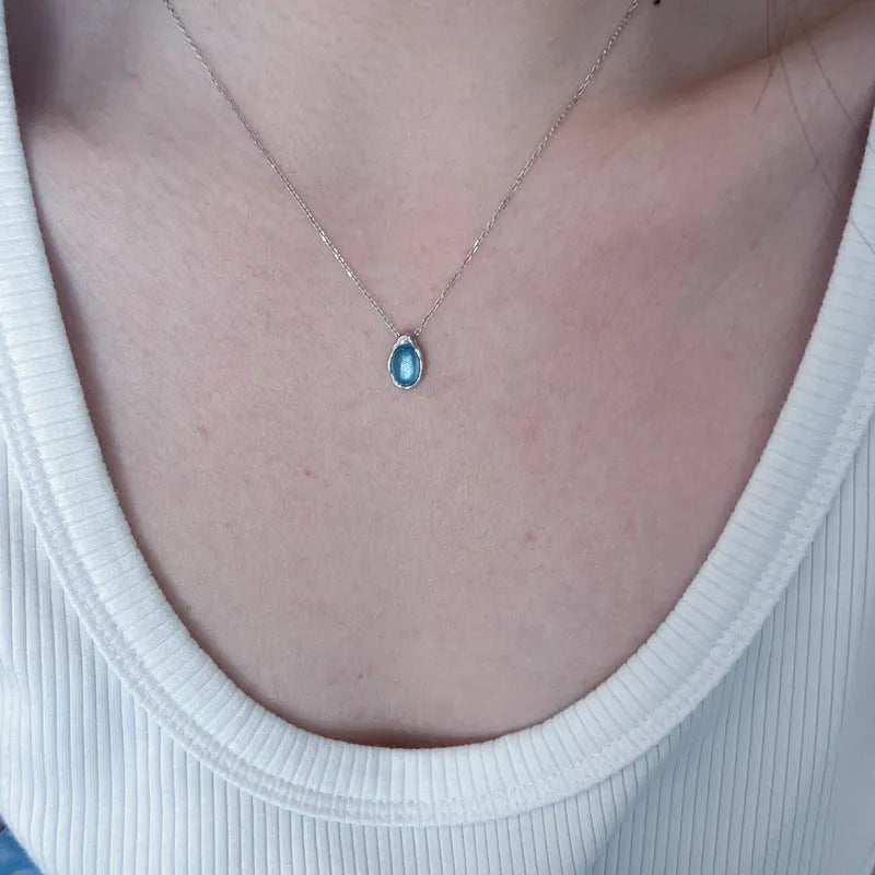 Women's navy blue water drop necklace with geometric pendant on adjustable copper chain