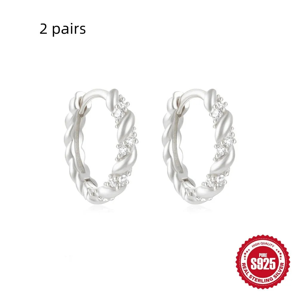 Sterling silver geometric stud earrings with small round design elements in gold or silver finish