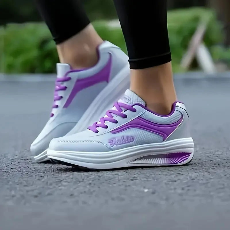 Women's grey powder mid-heel sports shoes for travel, shown from the side.