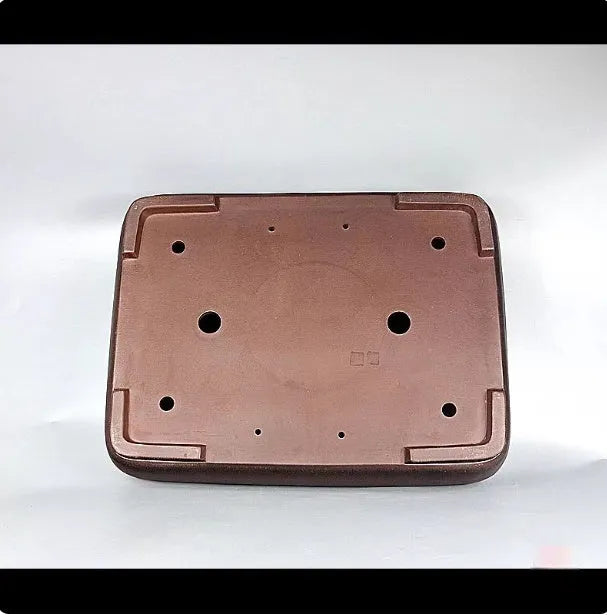 Handmade antique rectangular purple clay flower pot on tabletop