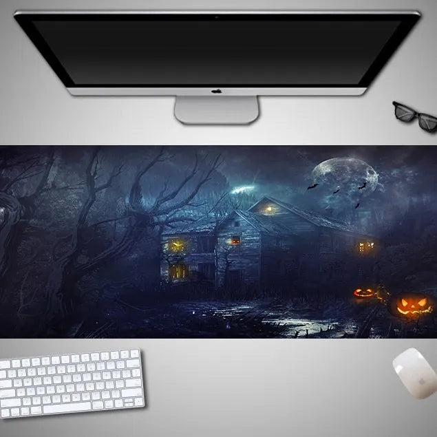 Large Halloween-themed computer mouse pad with graphic design on a desk