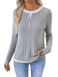 Women's black fake two-piece pullover sweater with round neck and long sleeves.