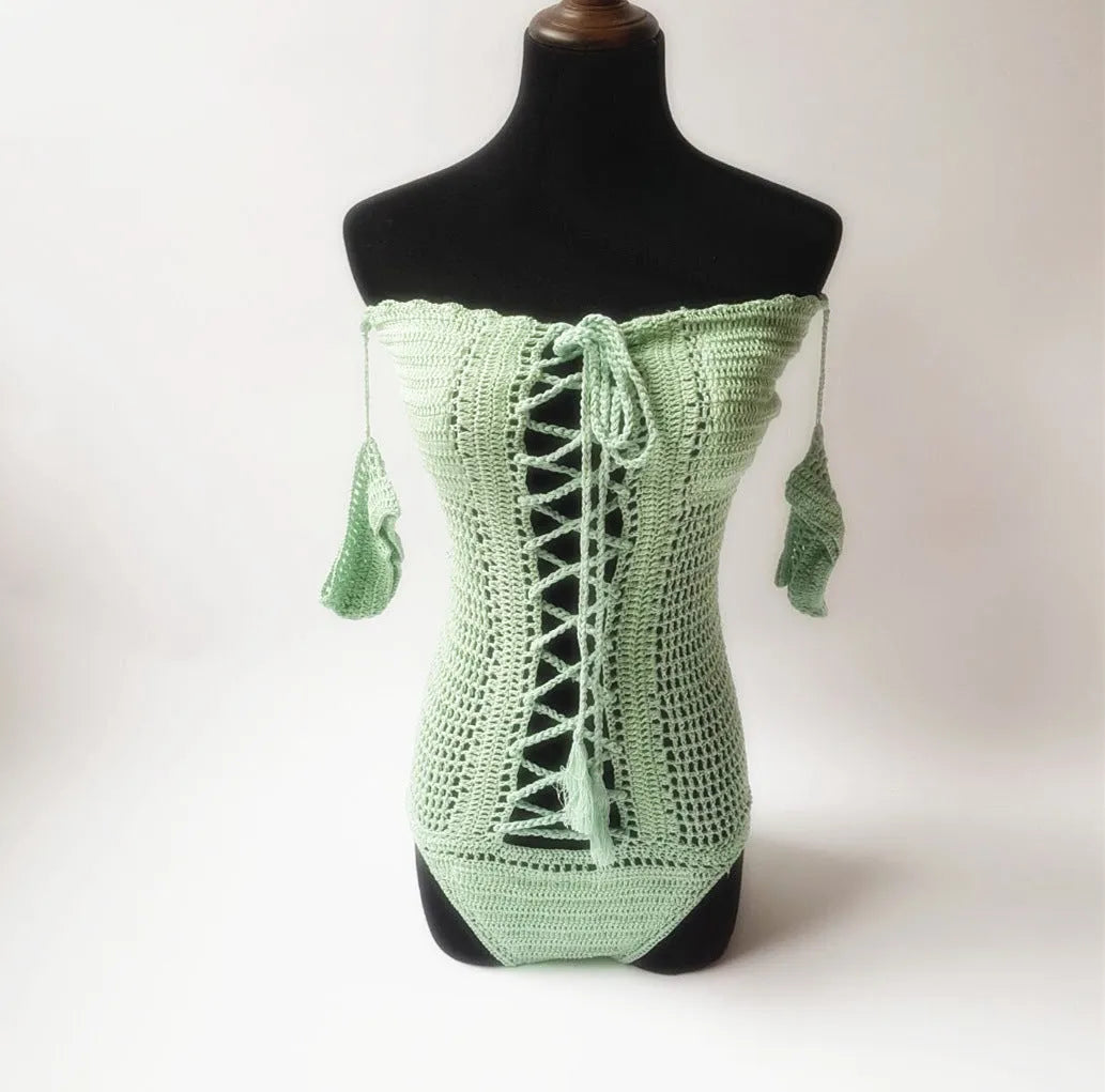 Women's white off-the-shoulder one-piece swimsuit on a mannequin, showing the neckline design.
