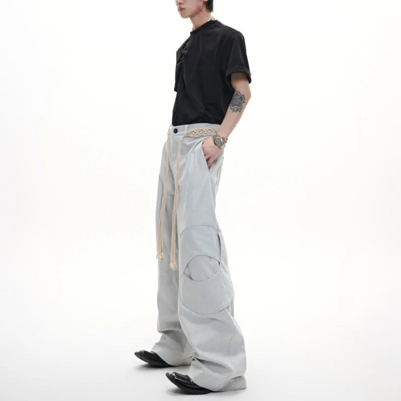 Men's dark blue cotton straight-leg jeans with loose fit, showing 3D cutting and belt stitching detail.