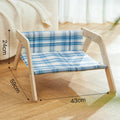 Wooden elevated cat bed with blue cloth cushion for indoor cats