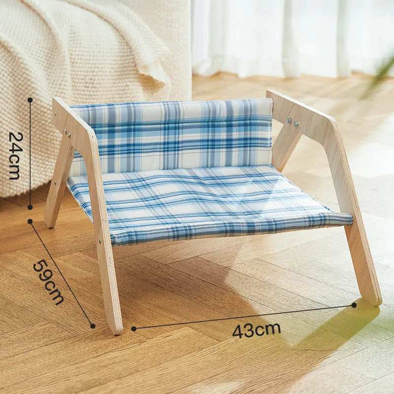 Wooden elevated cat bed with blue cloth cushion for indoor cats