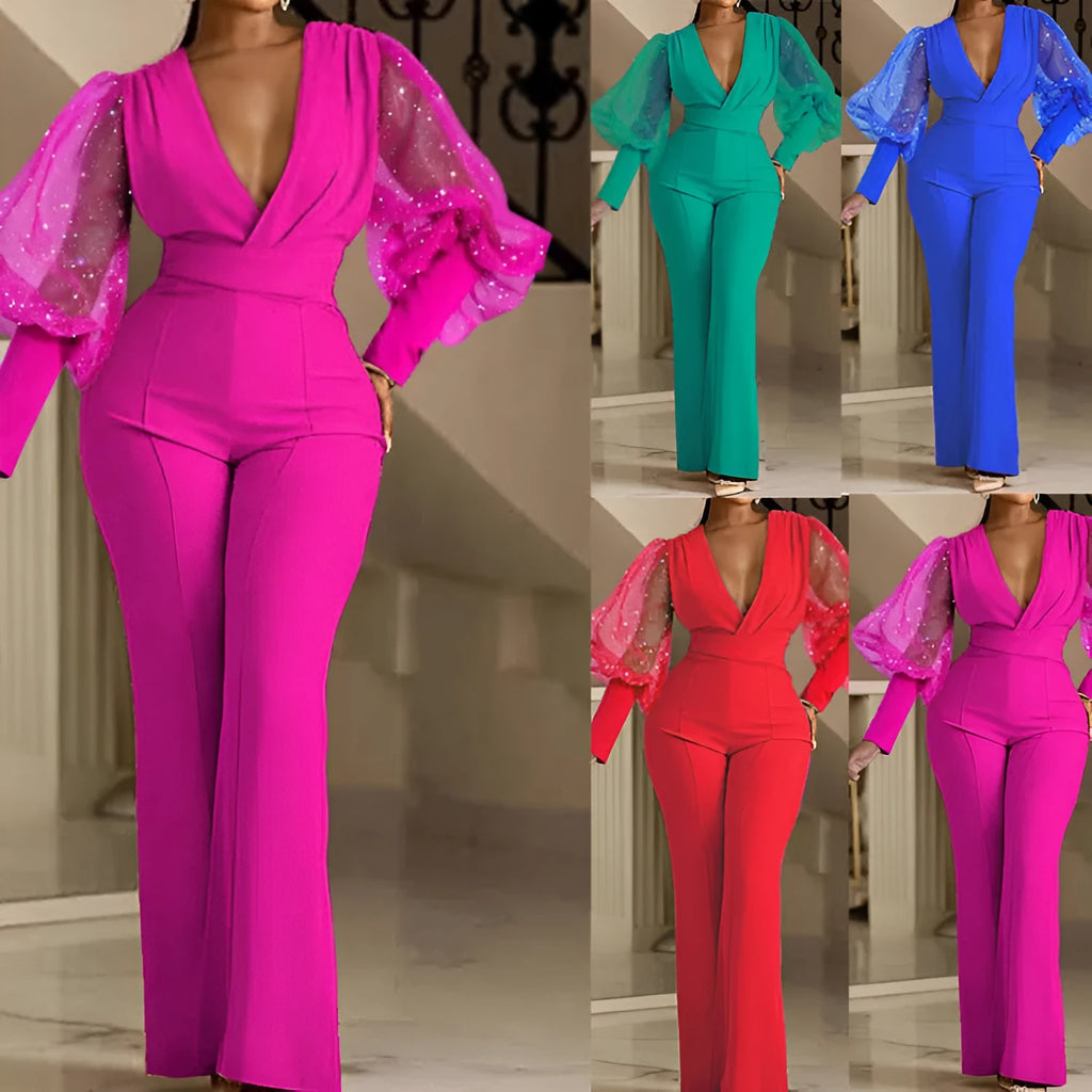 Red women's jumpsuit with mesh stitching detail on the bodice, long sleeves, and wide leg trousers.