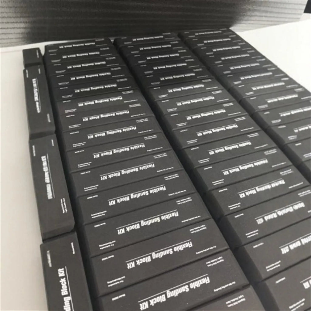 Seven black EVA frosted building blocks arranged for scale modelling and prototyping