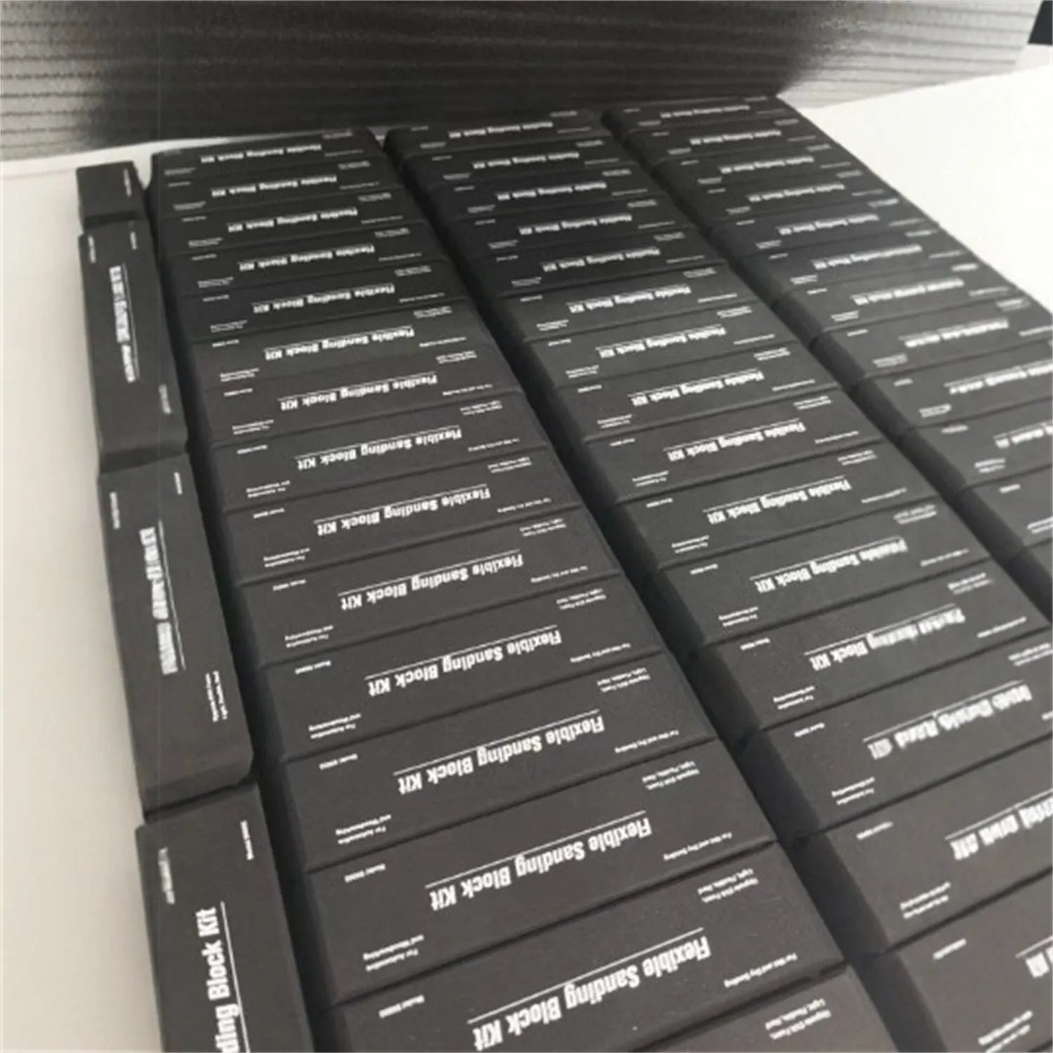 Seven black EVA frosted building blocks arranged for scale modelling and prototyping