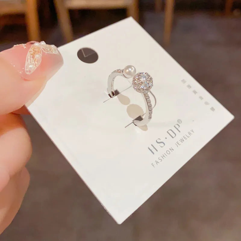 Gold plated open-end ring with round zircon accents on a geometric copper band