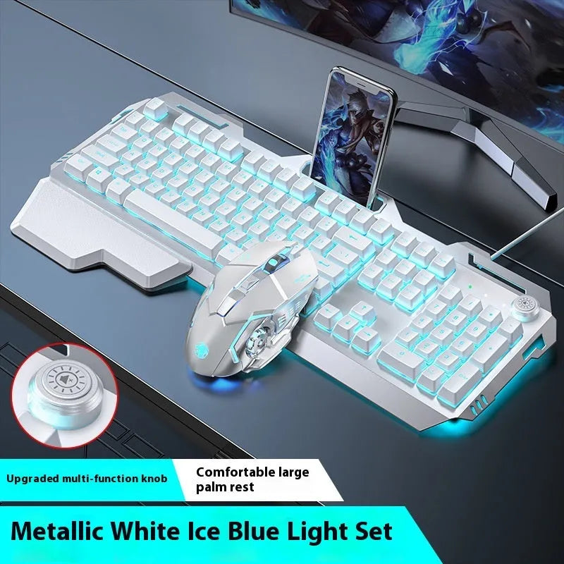Aluminium gaming keyboard with volume knob, shown in metal grey with RGB lighting alongside optional macro mouse and headset.