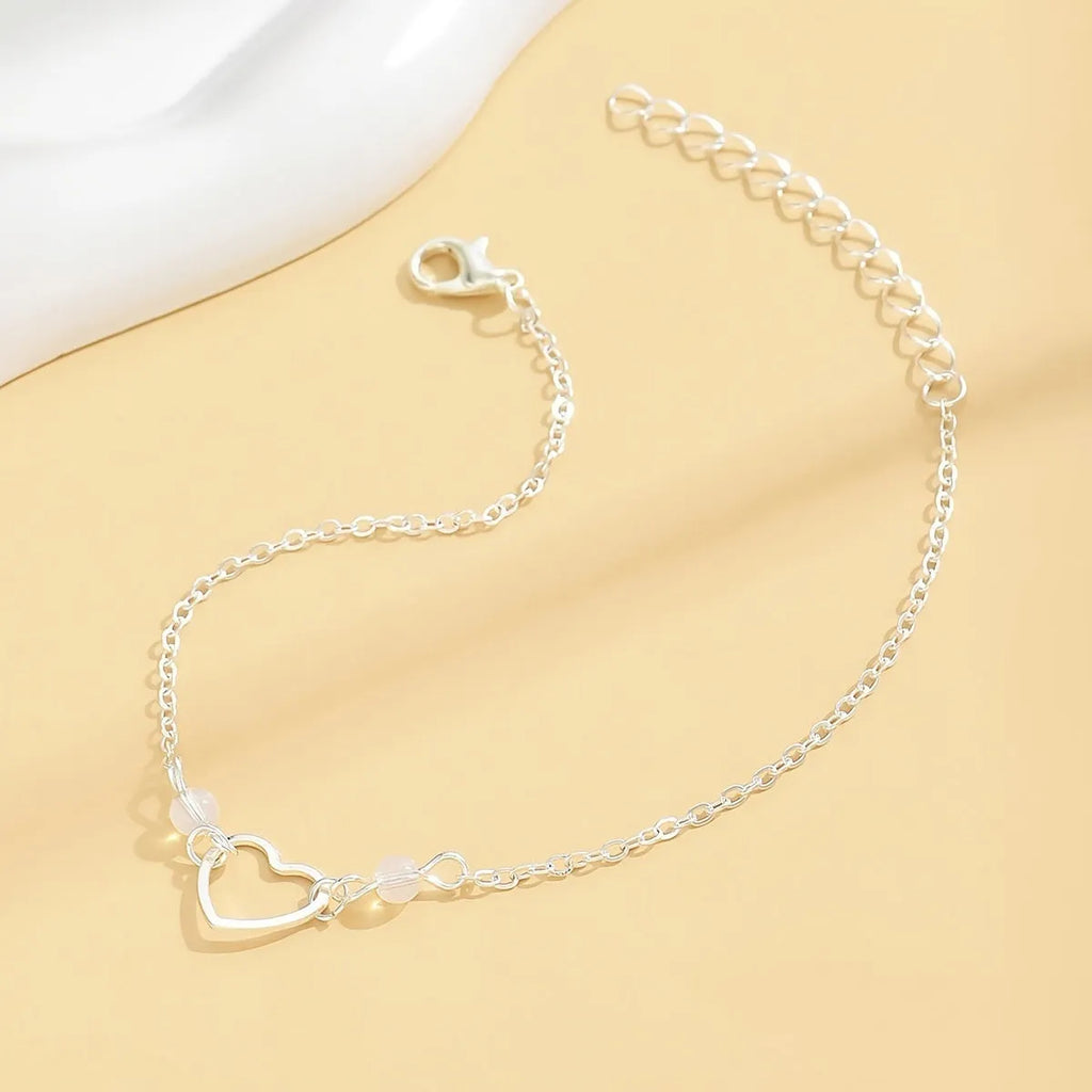 Adjustable women's anklet with heart-shaped pendant in gold or silver alloy metal