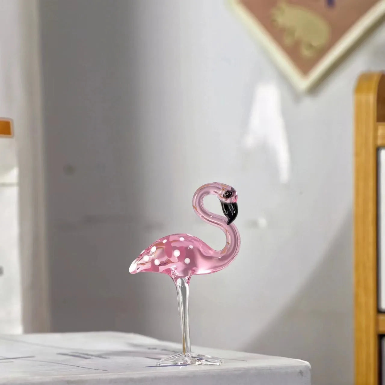 Pink crystal flamingo decorative ornament on table, available in separate or parallel styles.