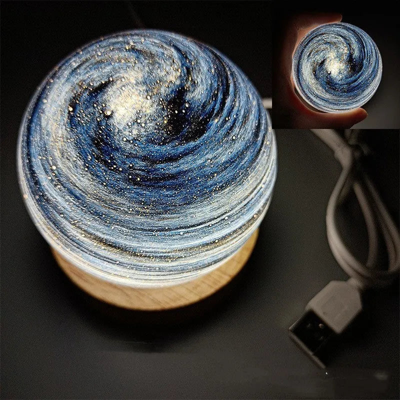 Planets themed USB night light with modern design and three-colour dimming on bedside table.